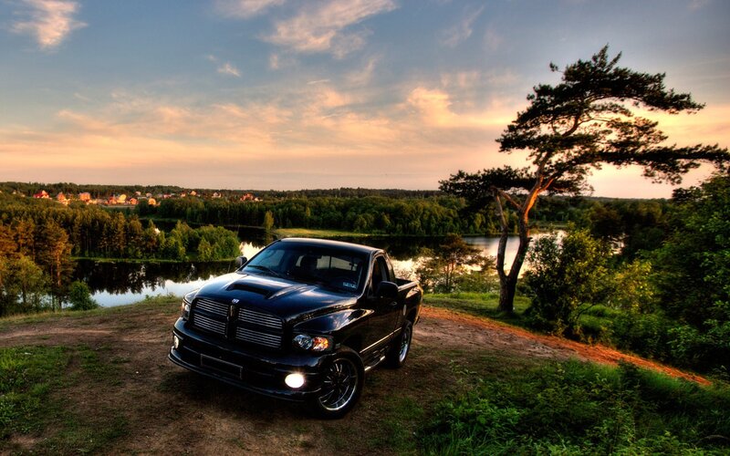 Black truck on a hill at sunset