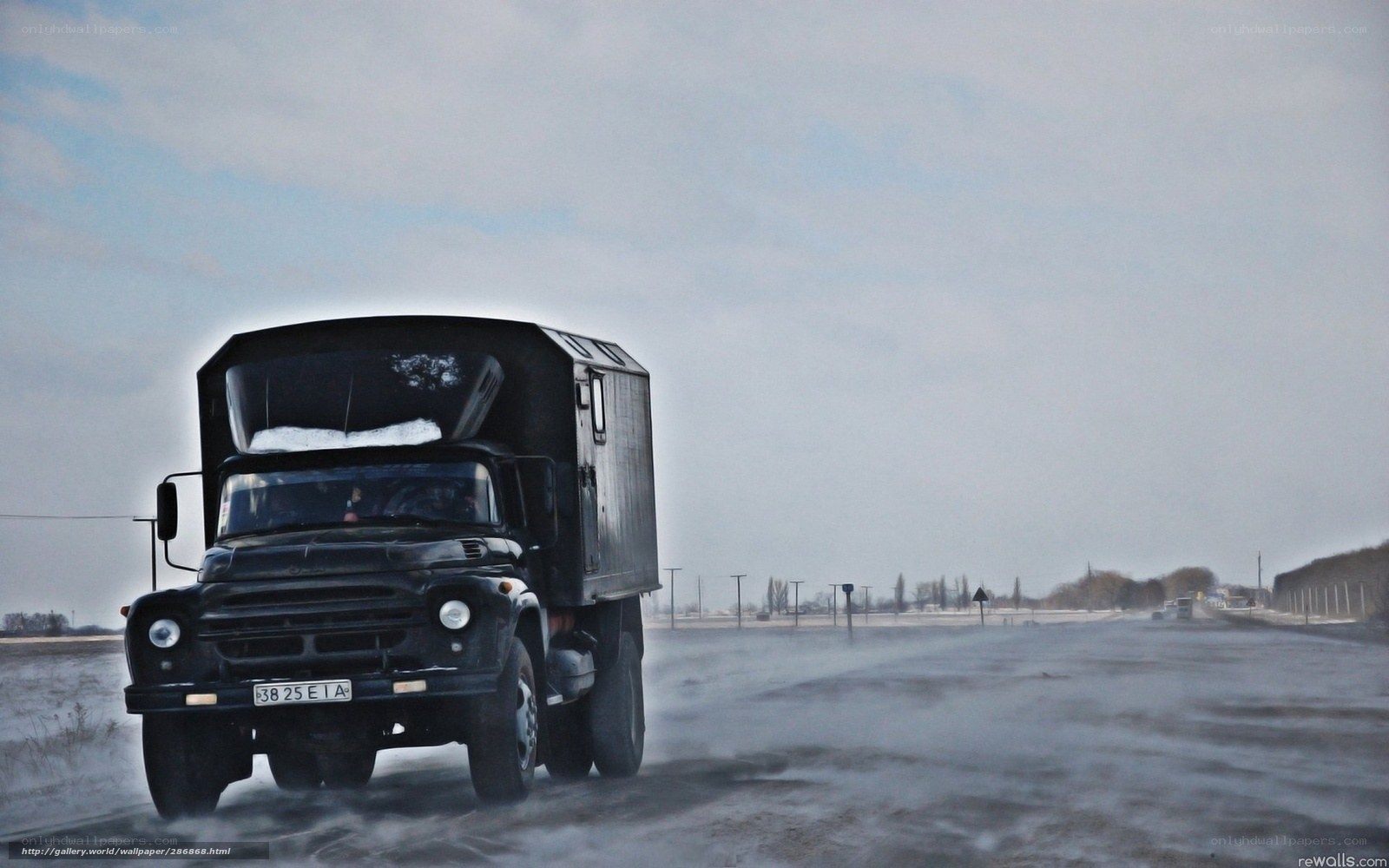 Black truck on snowy road