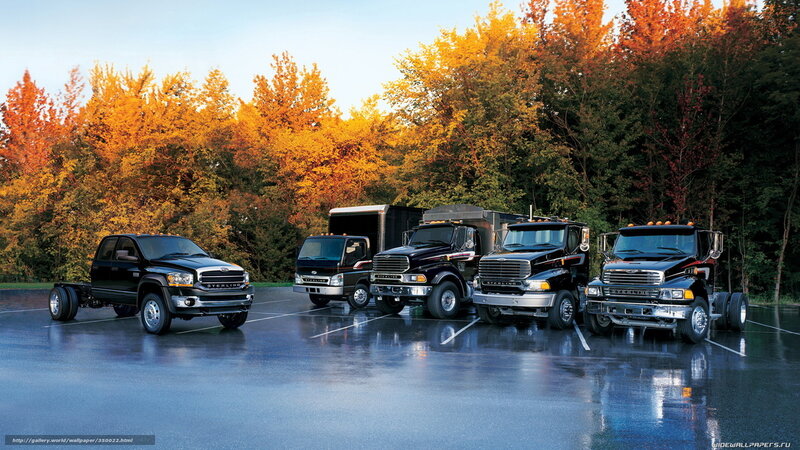 Black trucks in autumn parking lot
