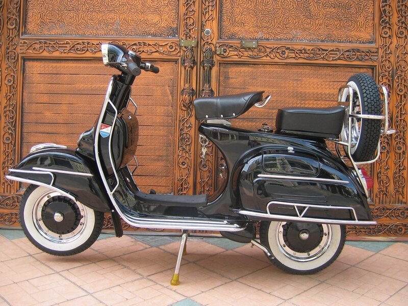 Black Vespa scooter with spare tire