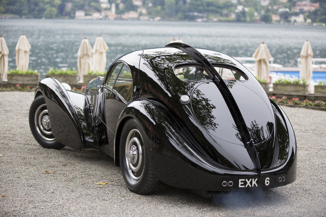 Black vintage Bugatti by a lake