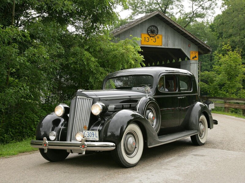 Black vintage car at covered bridge