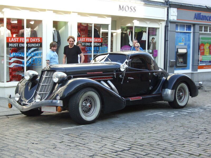 Black vintage car on cobblestone street