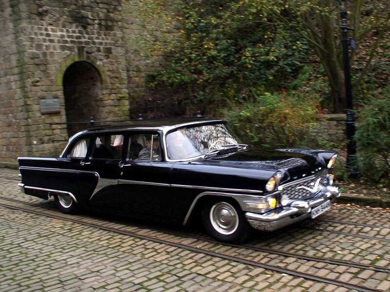 Black vintage car on cobblestones