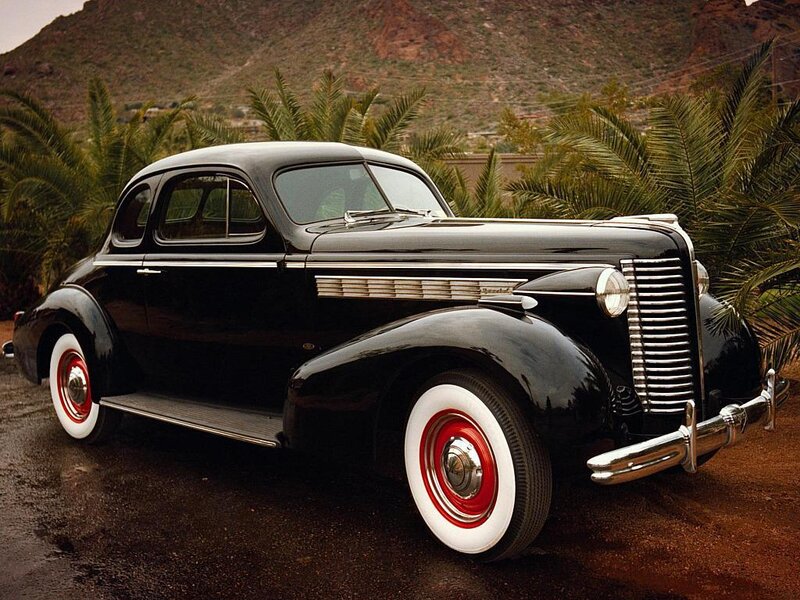 Black vintage car with red wheels