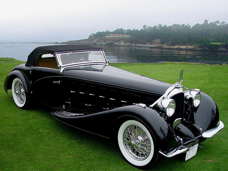 Black vintage convertible on grass