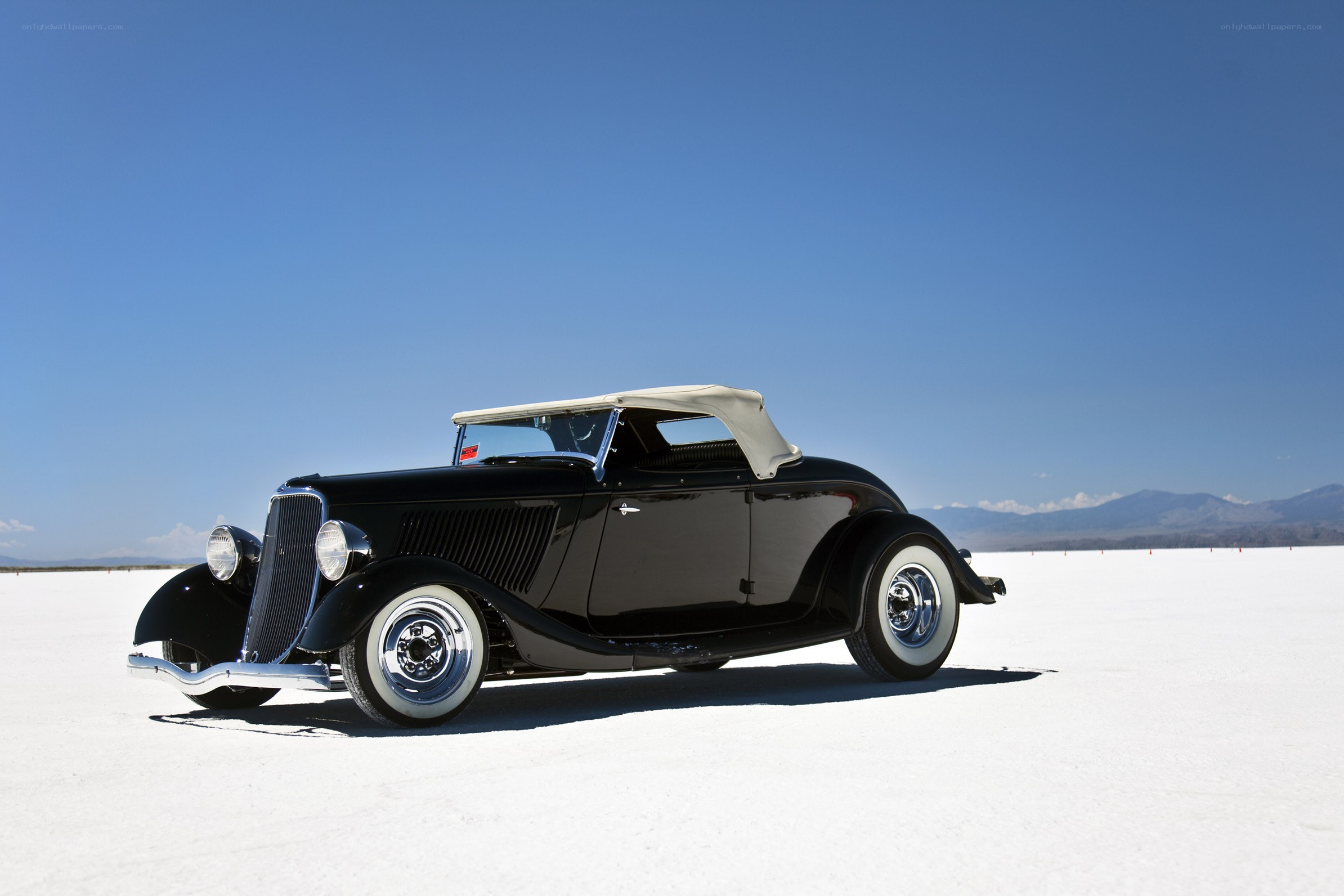 Black vintage convertible on salt flat