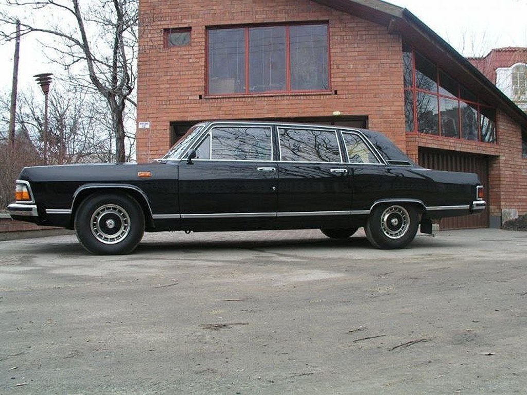 Black vintage limousine parked outside