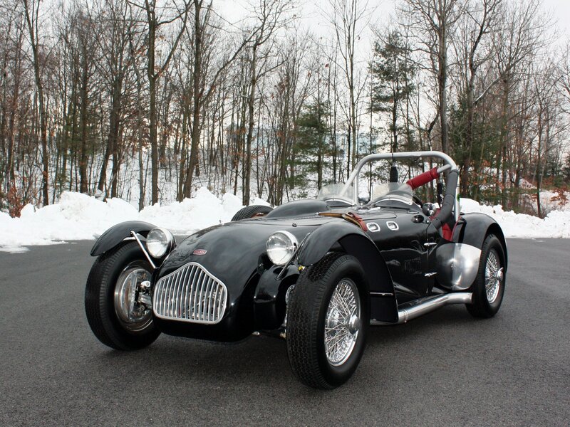 Black vintage roadster in snow
