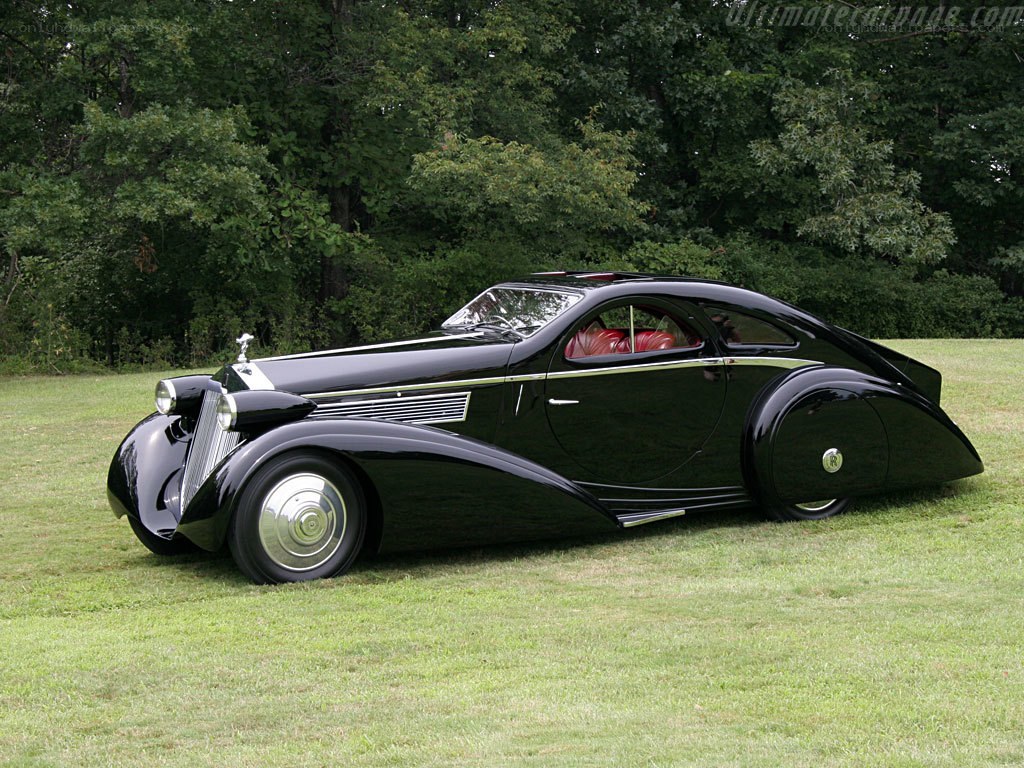 Black vintage Rolls-Royce on grass