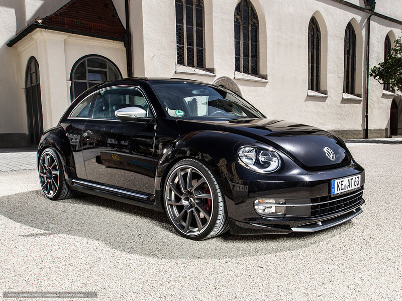 Black Volkswagen Beetle in front of church