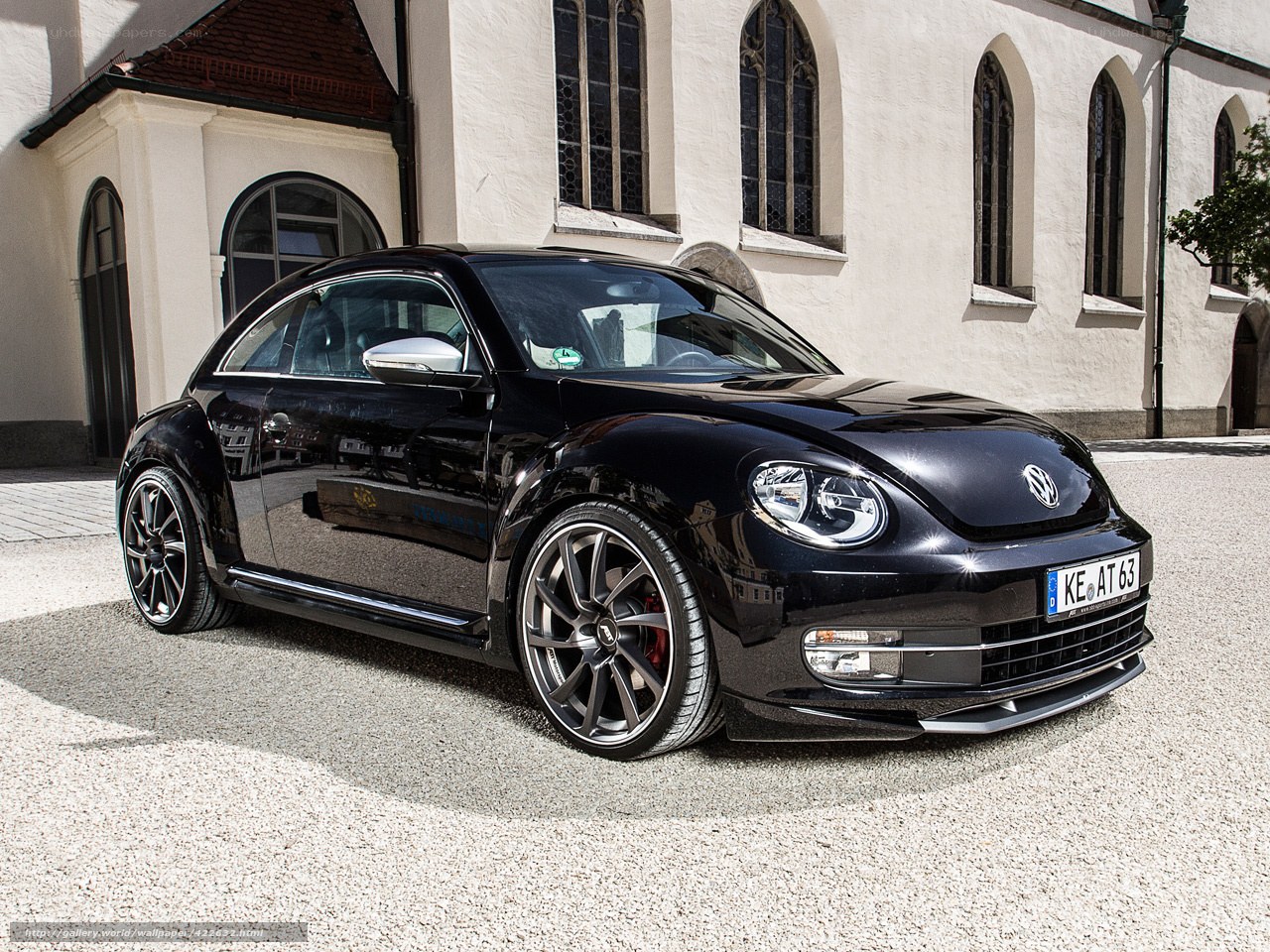 Black Volkswagen Beetle in front of church
