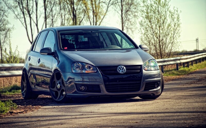 Black Volkswagen Golf on a country road