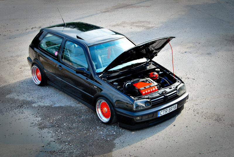 black volkswagen golf with red wheels