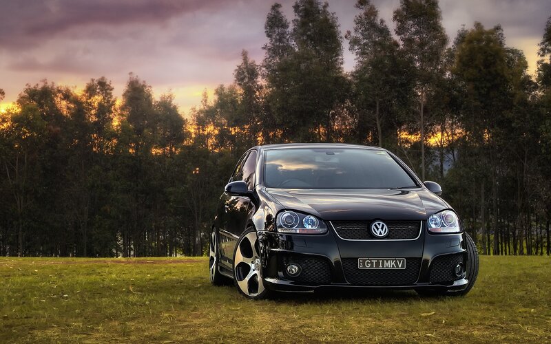 Black Volkswagen GTI at sunset