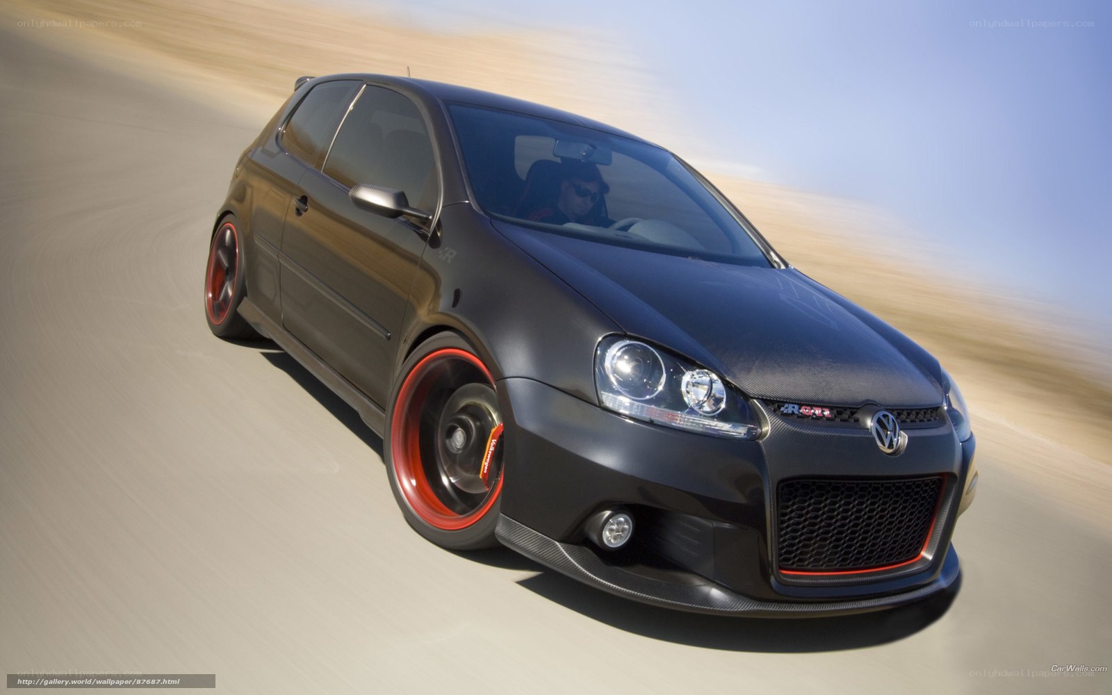 Black Volkswagen GTI in motion