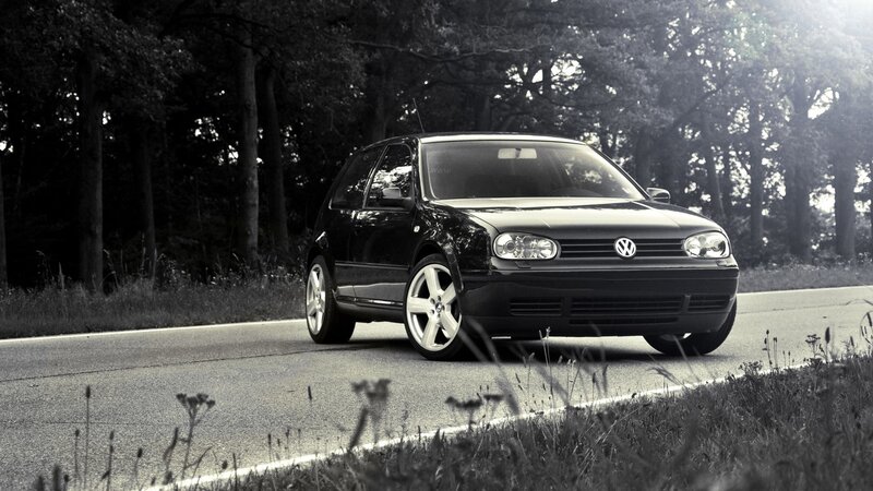 Black Volkswagen on a forest road