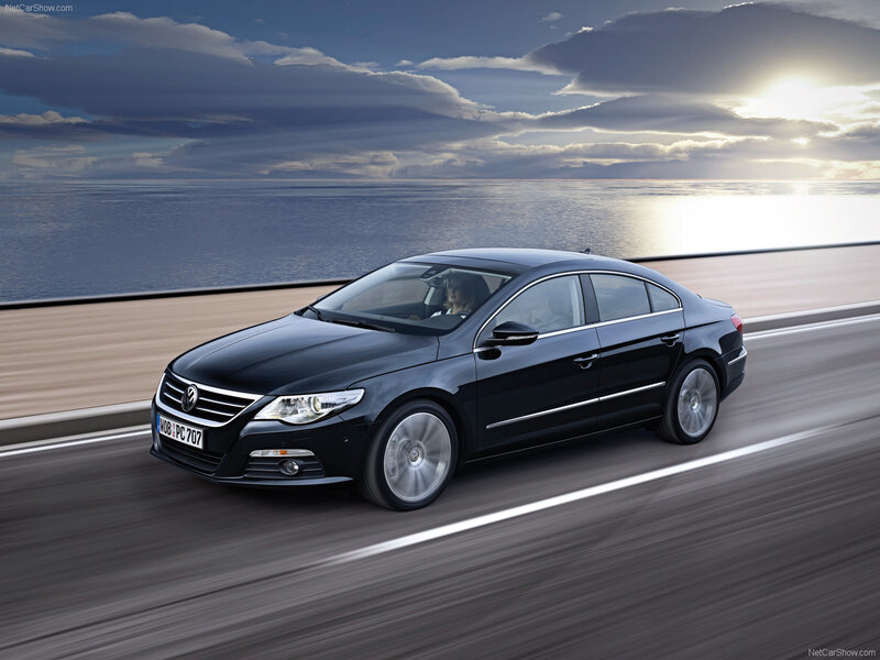 black volkswagen passat driving on coastal road