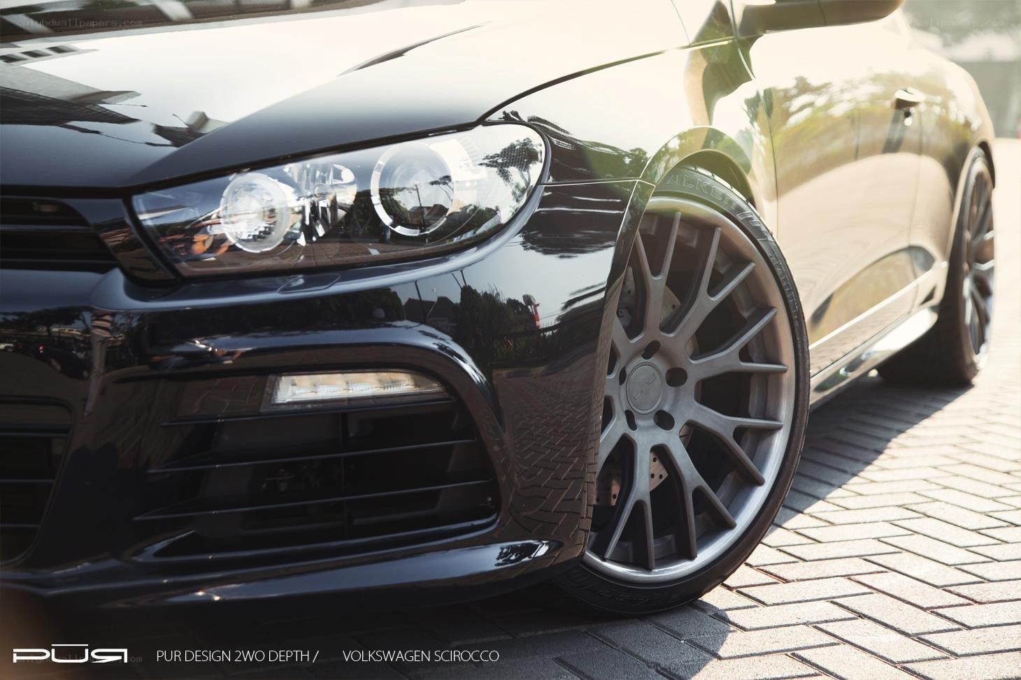 Black Volkswagen Scirocco with custom wheels