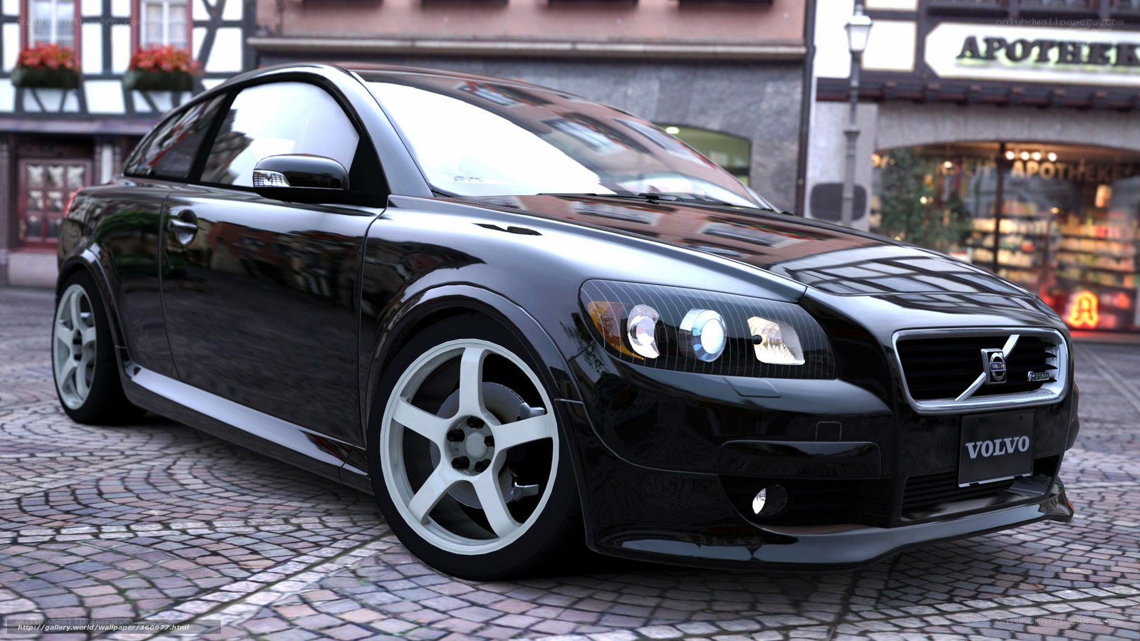 Black Volvo C30 on cobblestone street