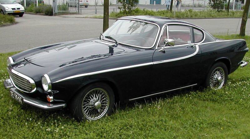 Black Volvo coupe on grass