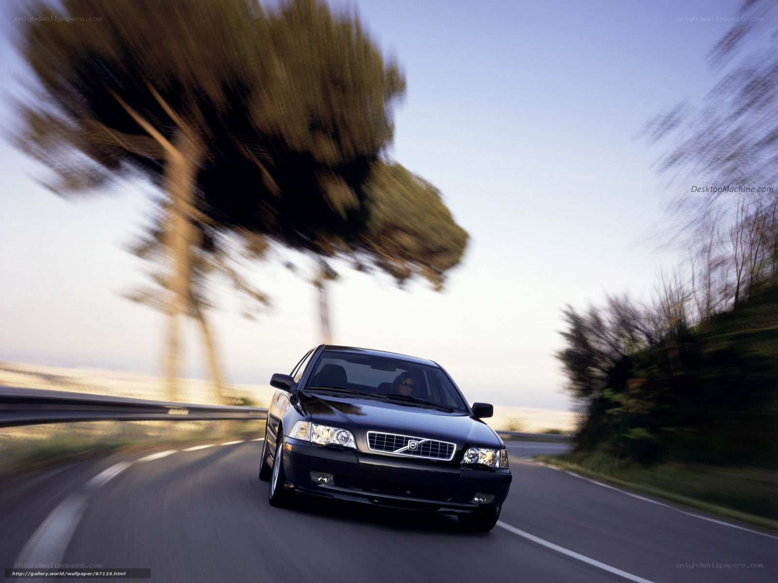 black volvo on winding road