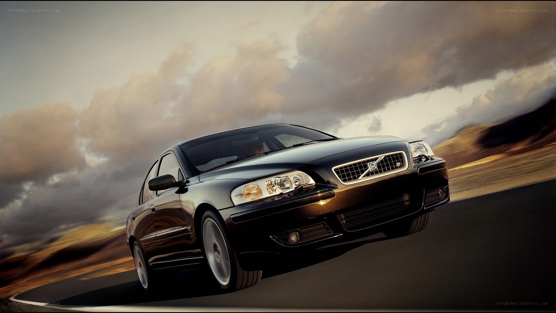 black volvo sedan in motion