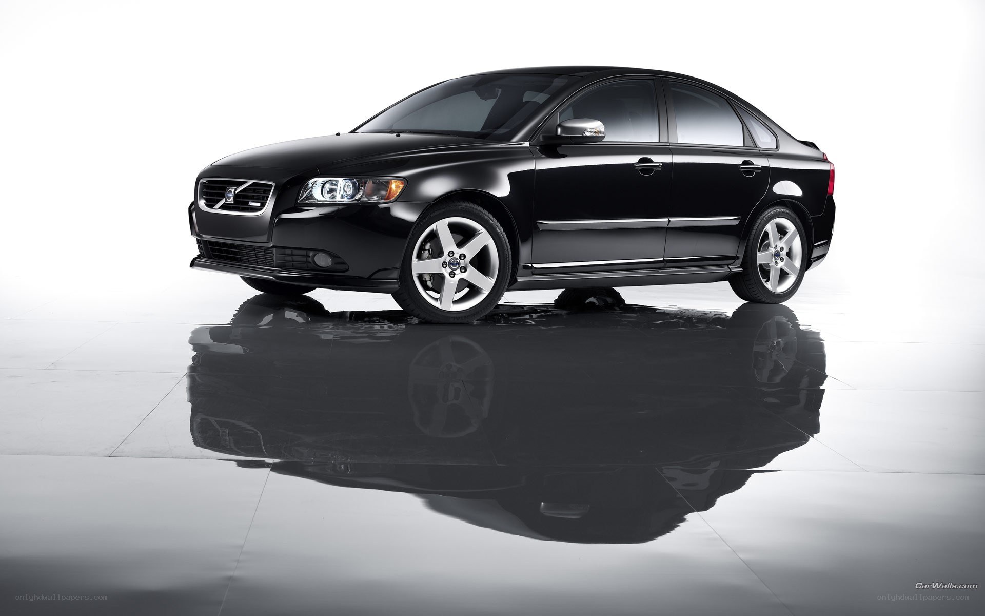 black volvo sedan on reflective surface