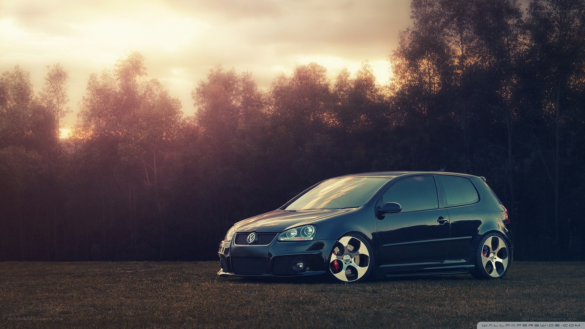 Black VW Golf GTI at sunset