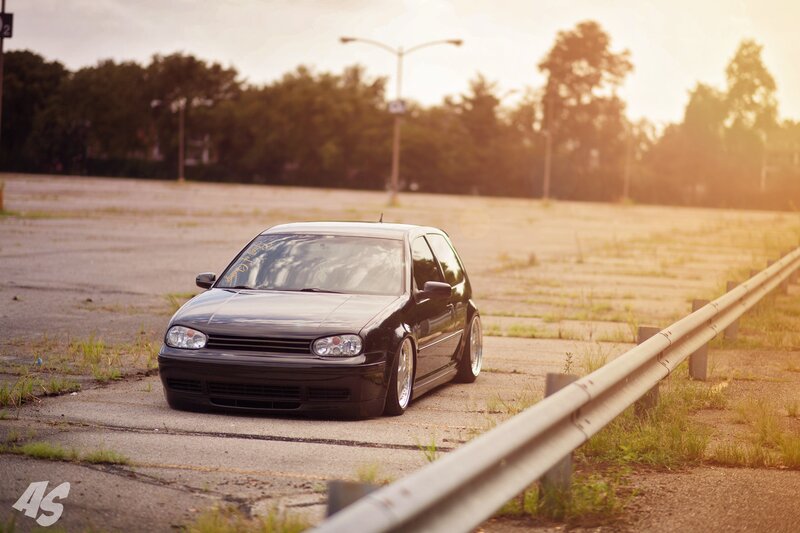 Black VW Golf in empty lot