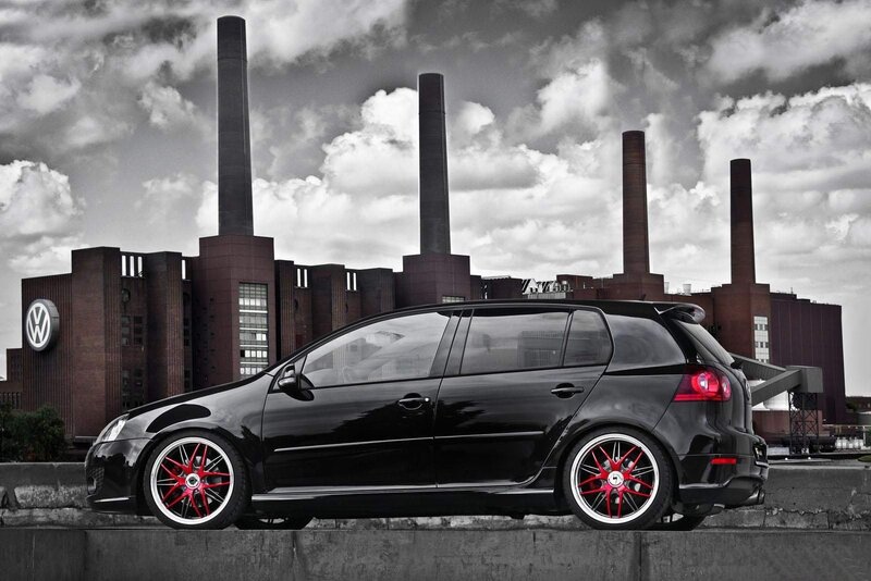 Black VW Golf in industrial setting