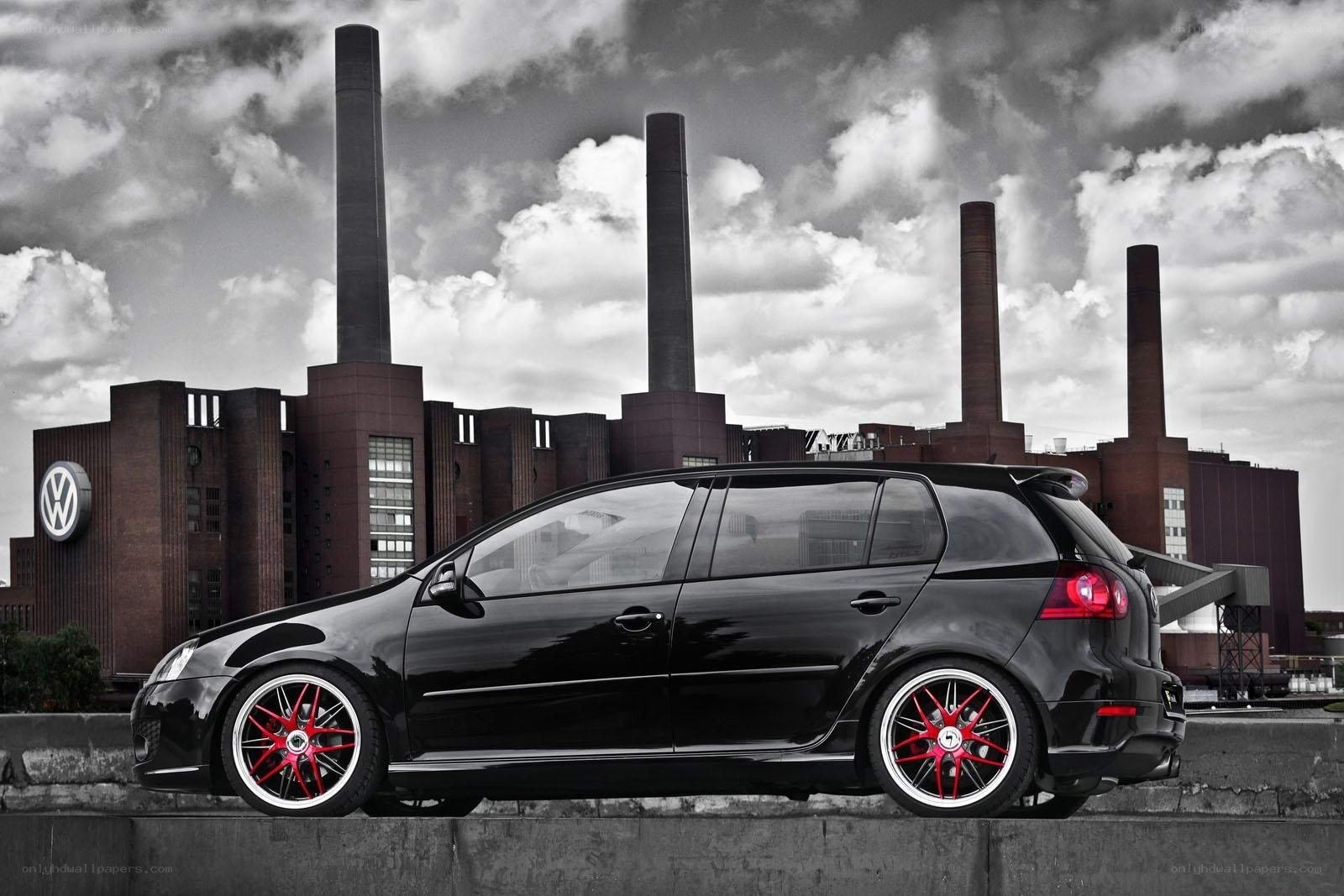 Black VW Golf in industrial setting