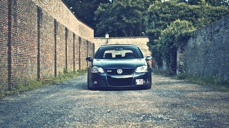 Black VW GTI on gravel path