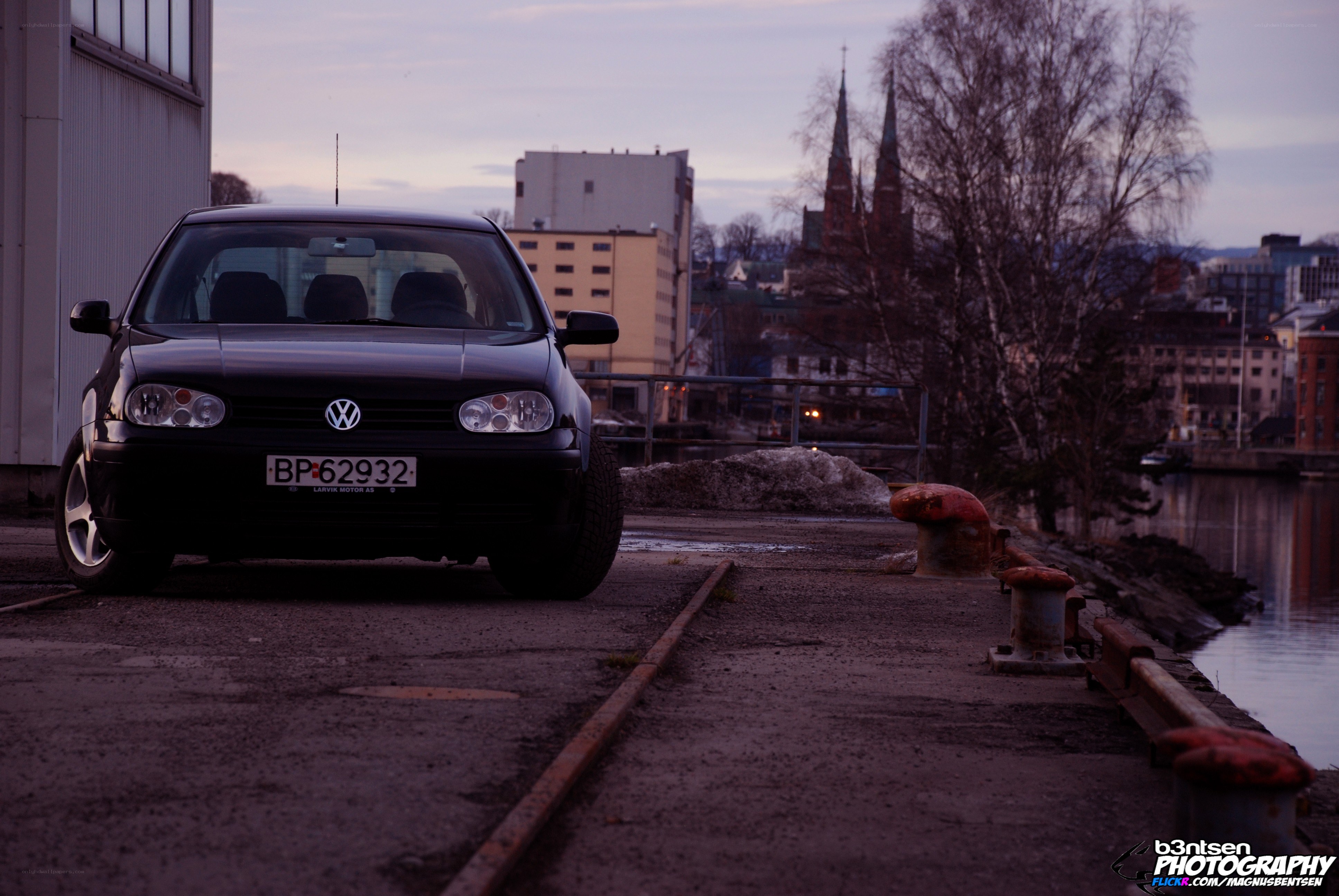Black VW on a dock at dusk
