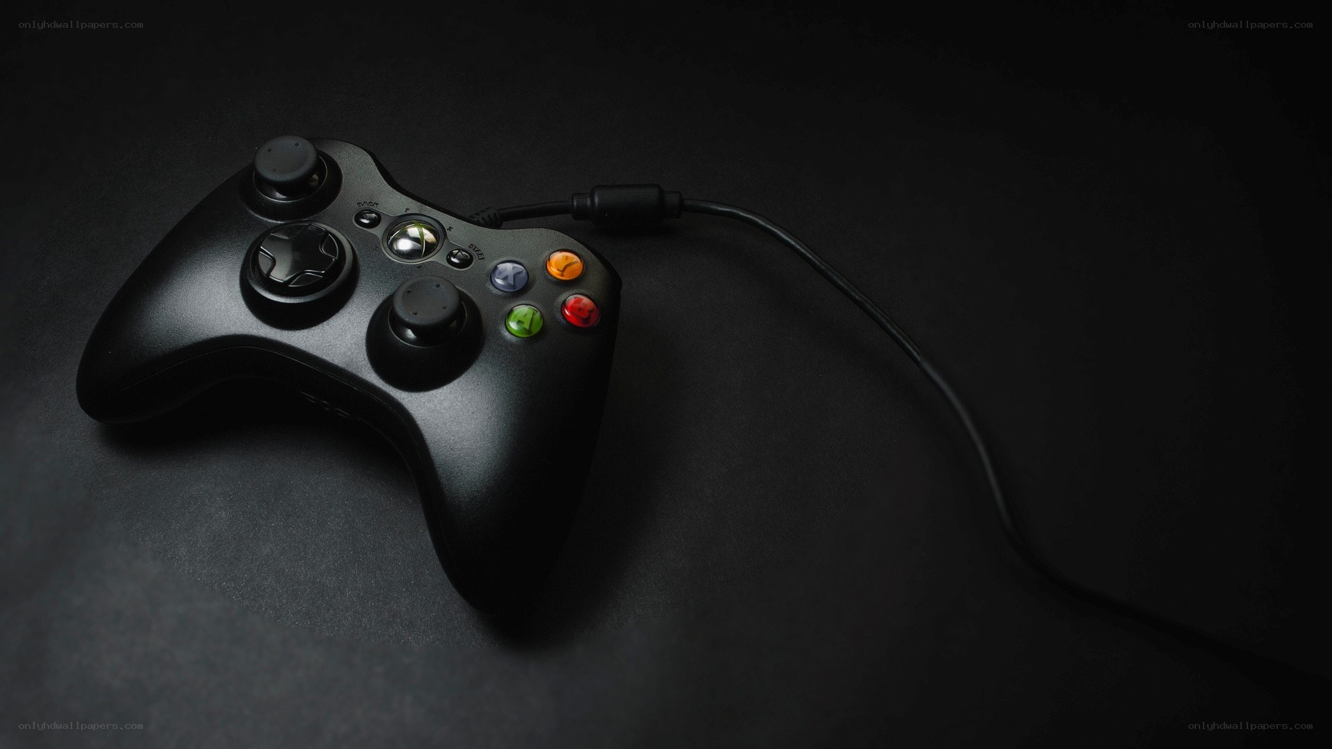 black xbox controller on dark surface