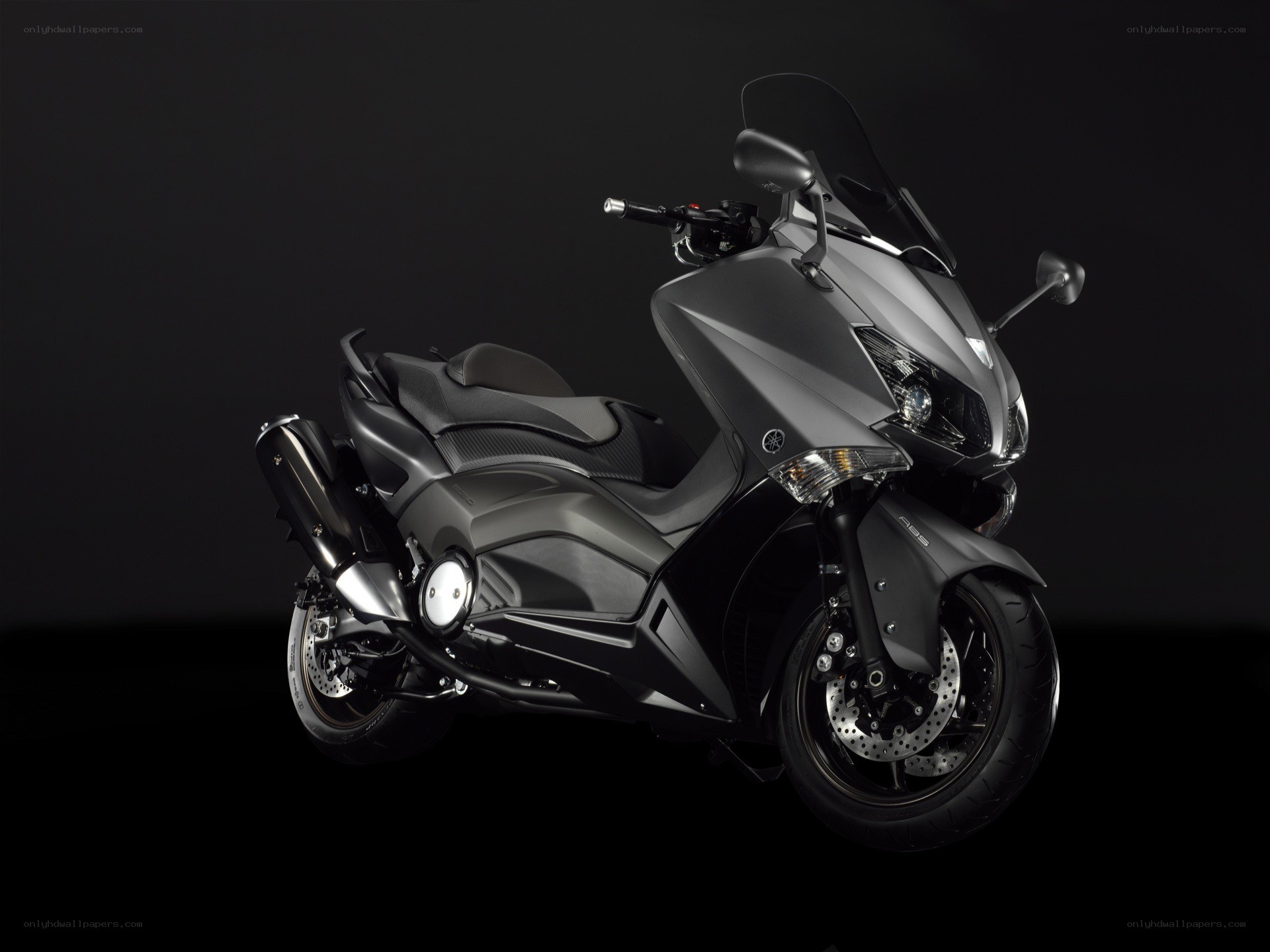 Black Yamaha scooter on dark background
