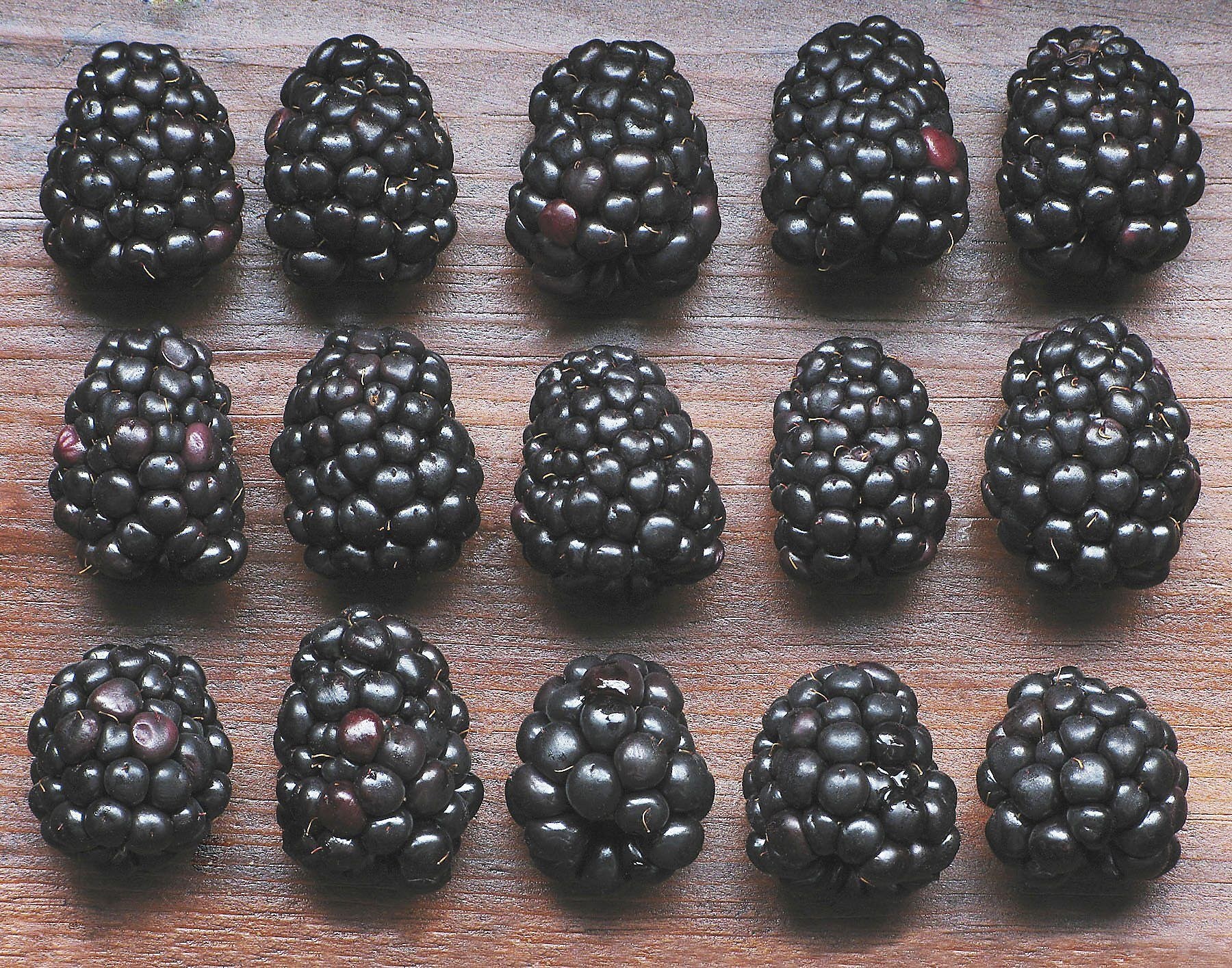 blackberries on wooden surface