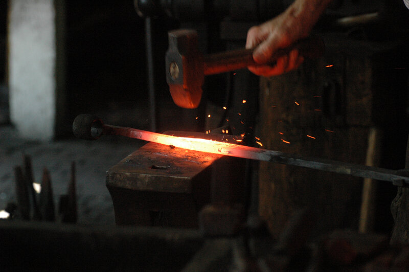 Blacksmith Forging Metal — Red