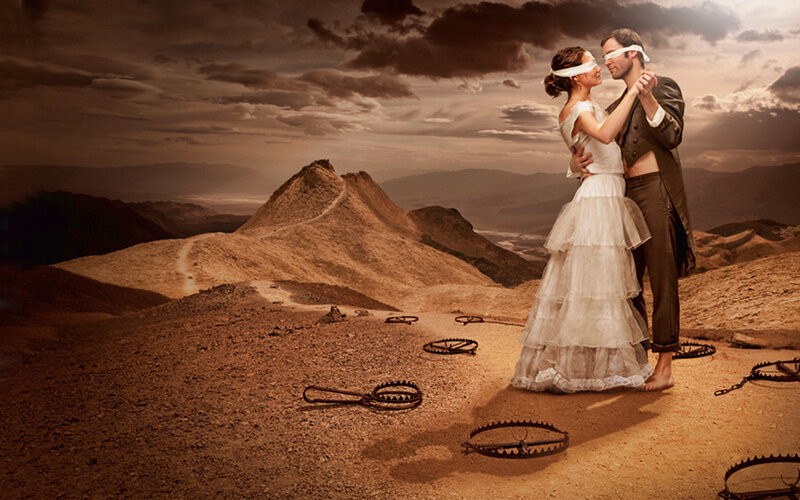 blindfolded couple in desert