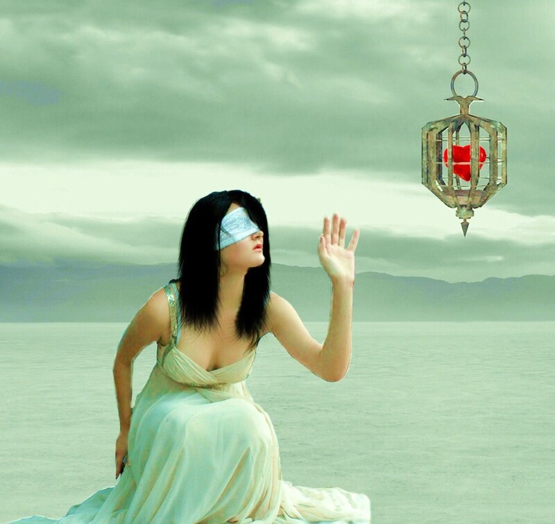 blindfolded woman reaching for heart