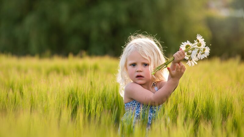 Blonde Child Holding Flowers