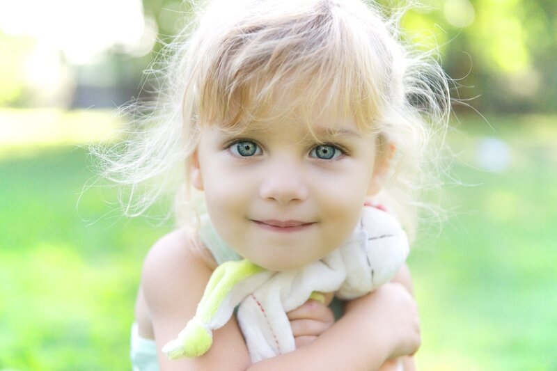 Blonde Child Holding Toy