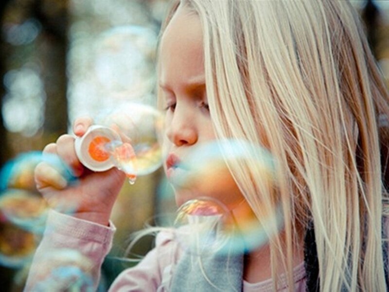 Blonde Girl Blowing Bubbles