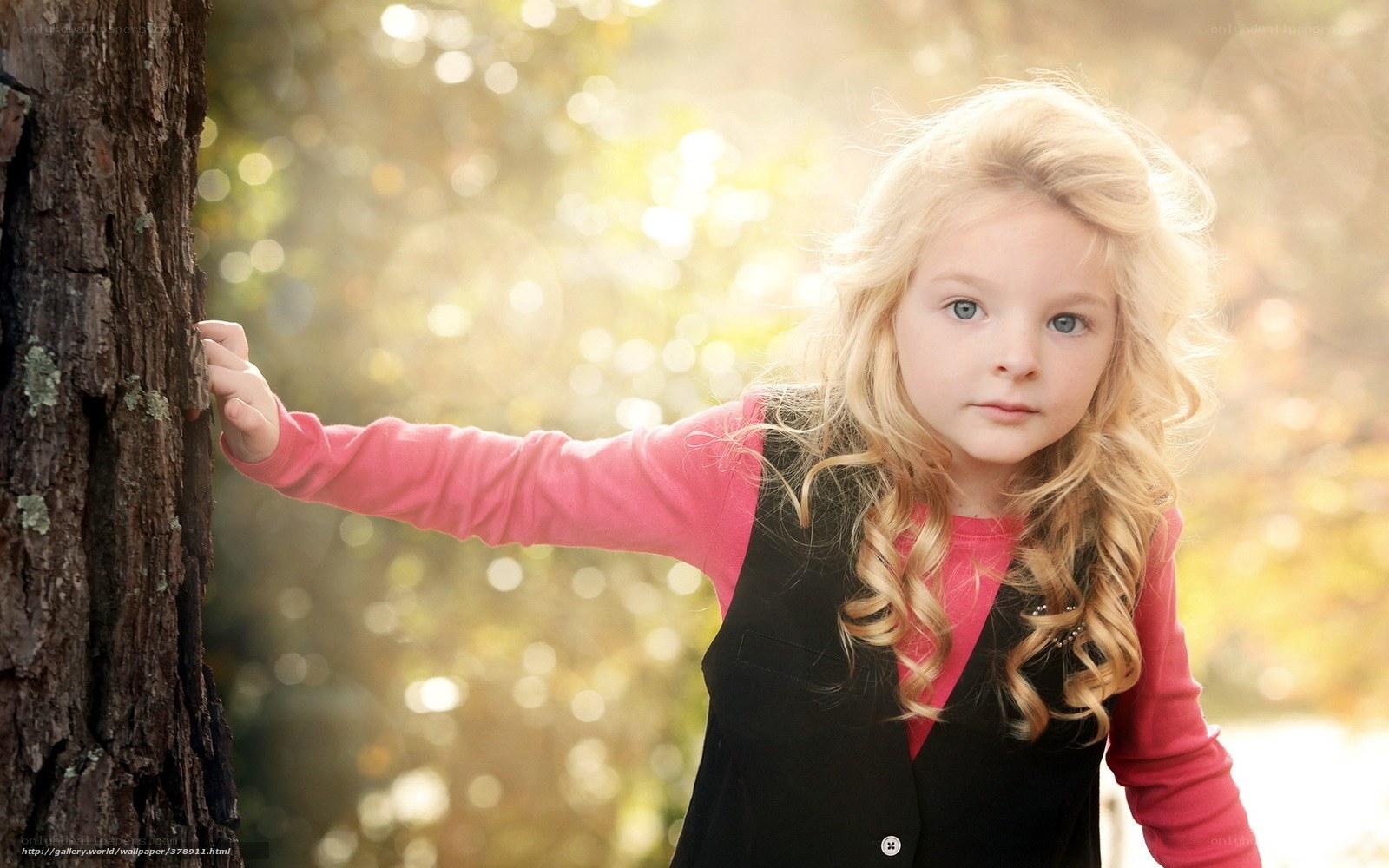 blonde girl by tree