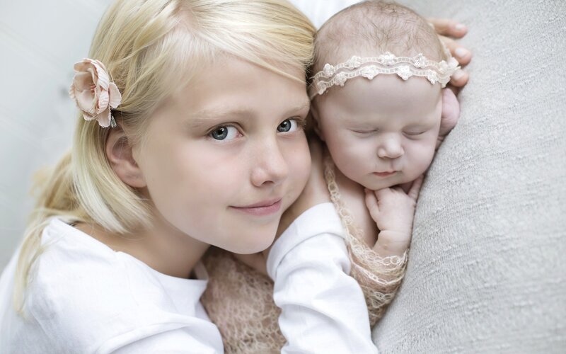 Blonde Girl Holding Baby