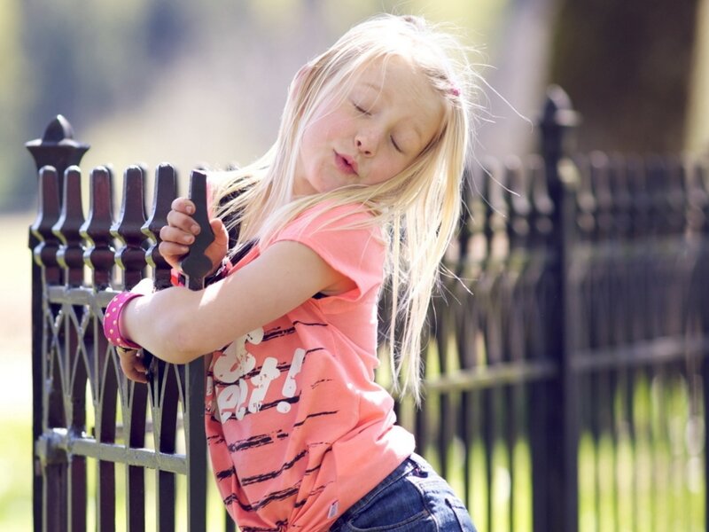 Blonde Girl Leaning on Fence