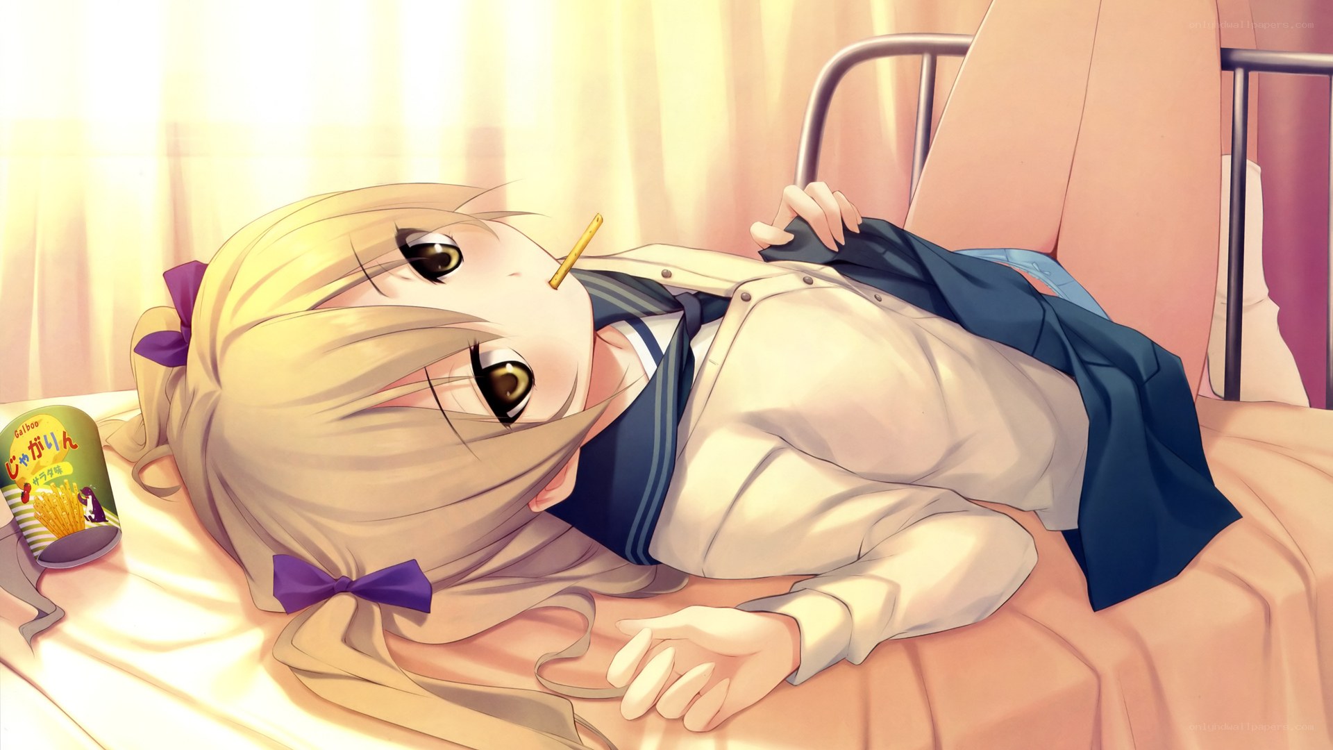 Blonde girl lying on bed
