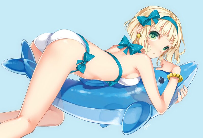 blonde girl on inflatable dolphin