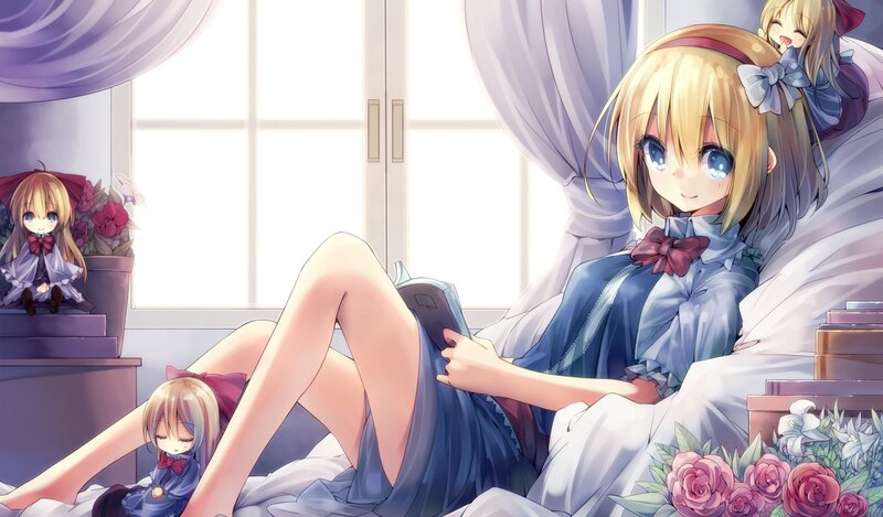 Blonde girl reading in bed