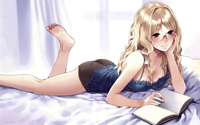 Blonde girl reading on bed